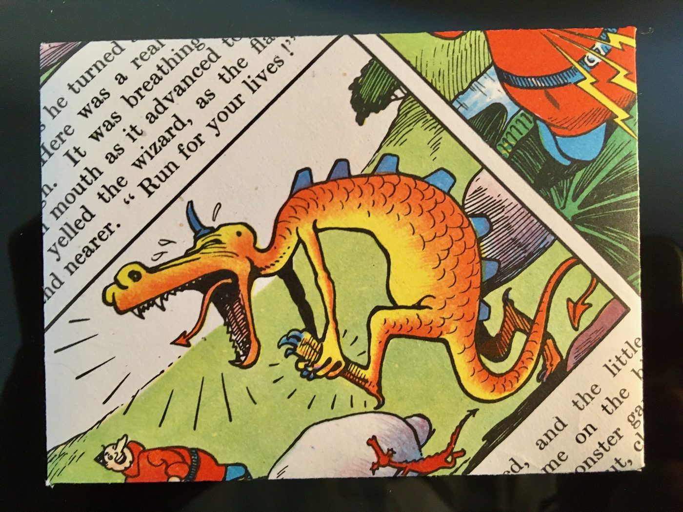 A handmade orange greeting card featuring a colourful vintage comic dragon